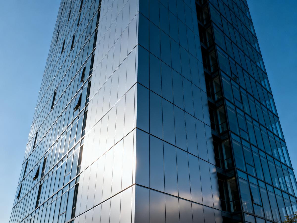 Modern building facade with large aluminum honeycomb panels.